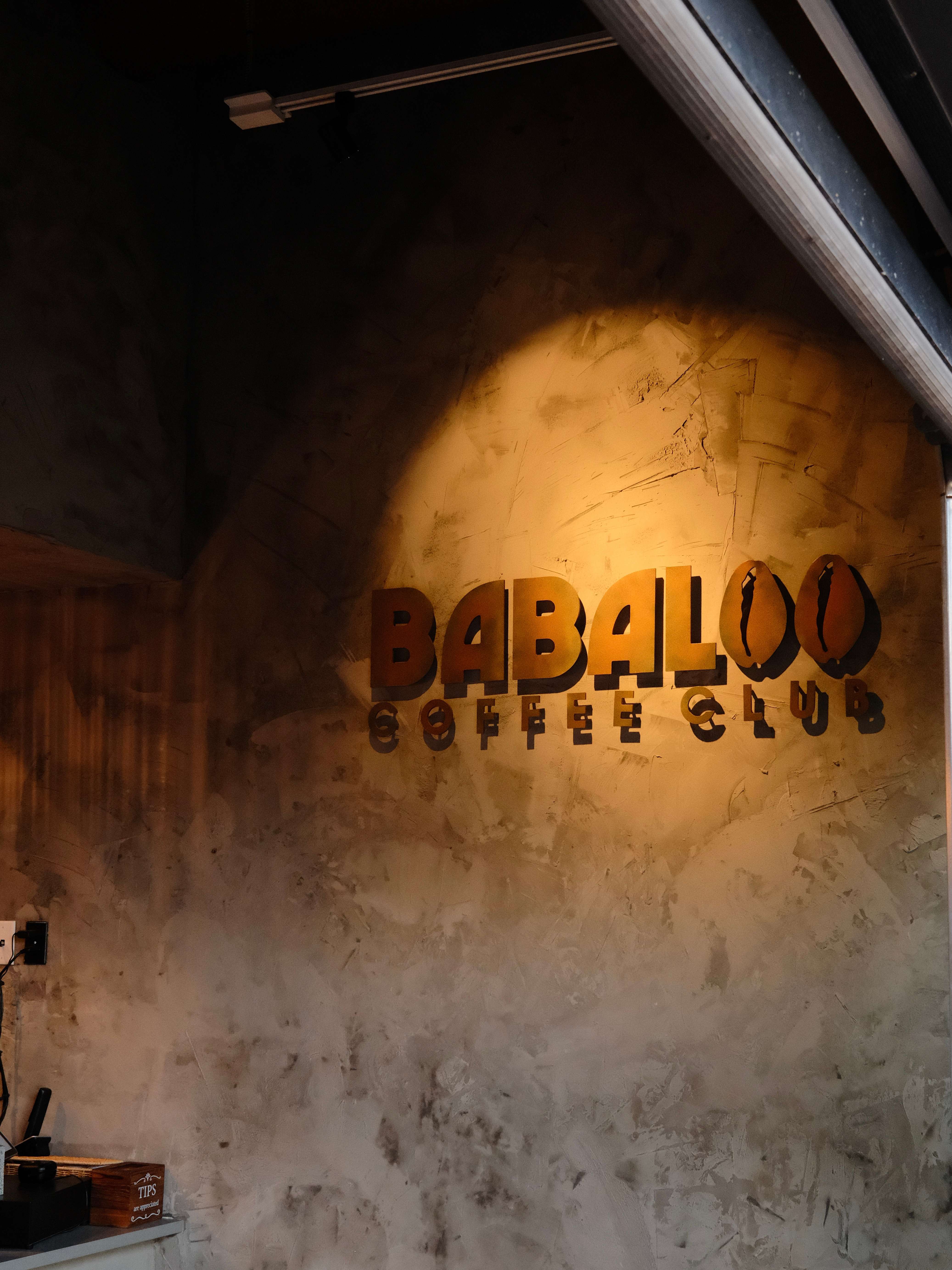 Working on a laptop with a Babaloo latte and a to-go cup